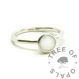 Ayla Breastmilk Ring breastmilk Ayla solitaire round band ring with classic milk, no sparkles. Solid 940 Argentium silver round shaped band ring setting. 6mm round bezel cup directly poured with preserved dried milk in resin. Breastmilk with resin in solid silver setting. Engraved inside in tiny Vivaldi font 0.8mm letters