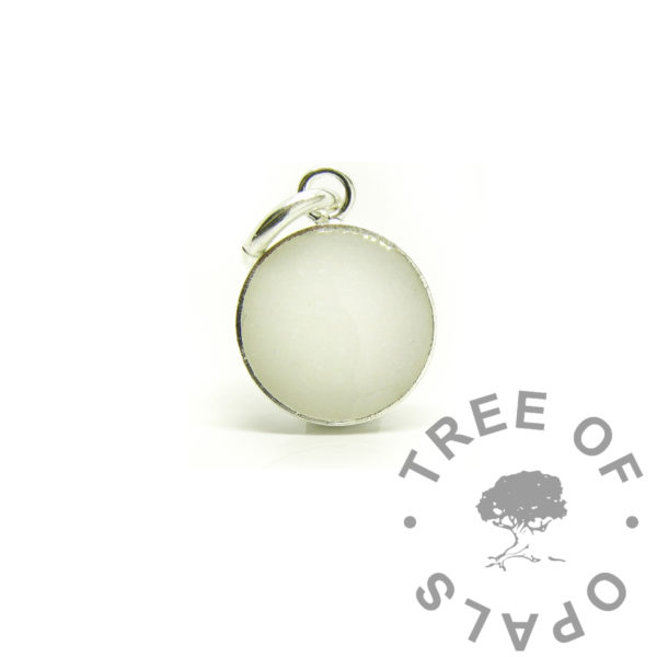 breastmilk dangle charm with classic milk, no sparkles. Solid 925 sterling silver round shaped necklace or dangle charm setting. 8mm round bezel cup directly poured with preserved dried milk in resin. Breastmilk with resin in solid silver setting. Engravable on the back or perfect proof photo piece to send to clients to check they are happy with the placement and colours of the inclusions. 2025 breastmilk jewelry