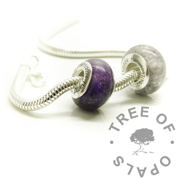 purple memorial bead duo shown on a snake chain necklace 20"/50cm. Cremation ashes and purple sparkle. Engraved bead cores with dates of birth and passing, arial font. Memorial jewellery in the UK. Solid sterling silver 925 stamped