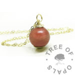 gold hair orb necklace red. Solid 9ct yellow gold setting with necklace chain. Hair and resin with dragon's blood red resin sparkle mix. 11m sphere handmade in the UK from scratch